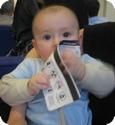 6 month old E eating his airline ticket