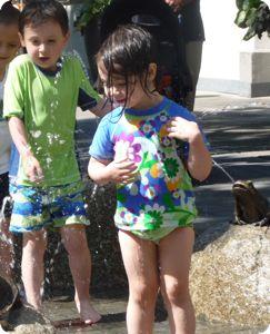Enjoying the waning days of summer in a splash fountain