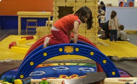 D climbs on one of the indoor play structures at Scientopia