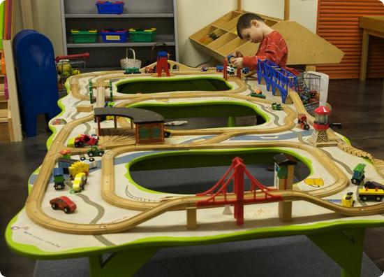 E plays at the train table at Scientopia in Napa