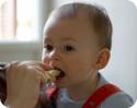 E taking a tentative bite of a mozzarella and tomato sandwich (he loved it)