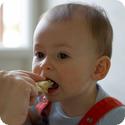 E taking a tentative bite of a mozzarella and tomato sandwich (he loved it)