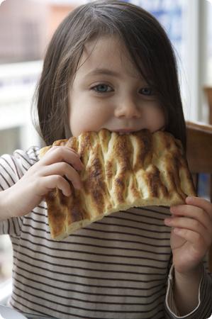 D enjoys fresh local bread at a restaurant in Istanbul