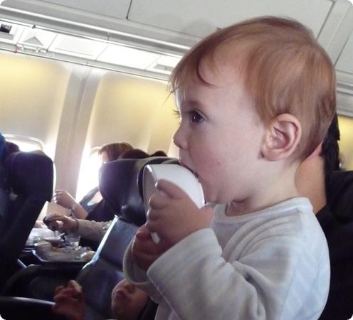 Eilan mouths an empty cup on our flight to Istanbul