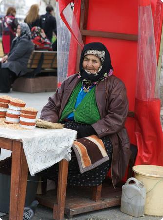 Woman selling pigeon feed outside of Istanbul's New Mosque 