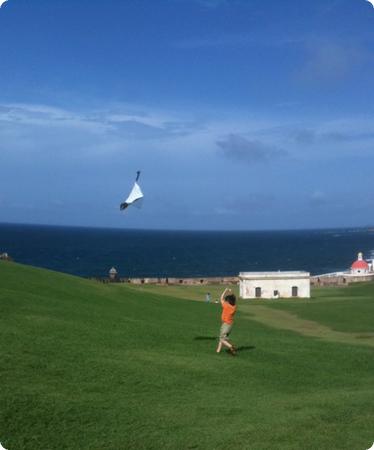 Everest flying his kite on the lawn at Castillo San Felipe del Morro in San Juan Puerto Rico
