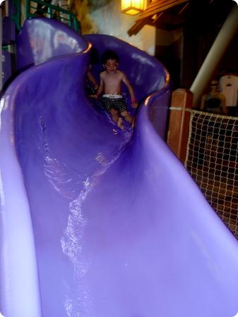 Everest and Darya slide down a preschool-sized slide at Great Wolf Lodge