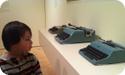 Everest "admires" the typewriters at SFMOMA