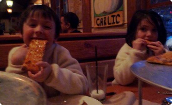 Everest and Darya feast on Creekbread's Cheese Flatbread