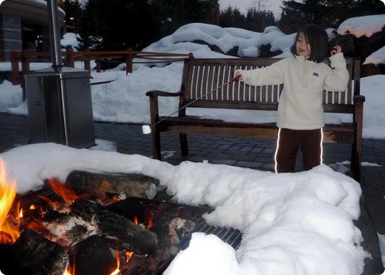 Darya bravely roasts her own marshmallow at the Four Seasons Resort Whistler fire pit 