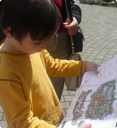 Everest studies a map of the Capilano Suspension Bridge in North Vancouver