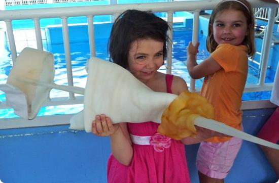 Darya holds Winter's Prosthetic Tail at the Clearwater Marine Aquarium