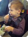 Eilan sits safely in his own airplane seat using the CARES harness