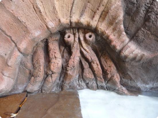 Crab hiding in a rock formation at Aulani's Menehune Bridge