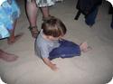 Eilan plays in the sand, oblivious to the crowds massed around him