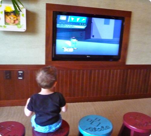 Eilan watches an early morning movie in the Aulani lobby