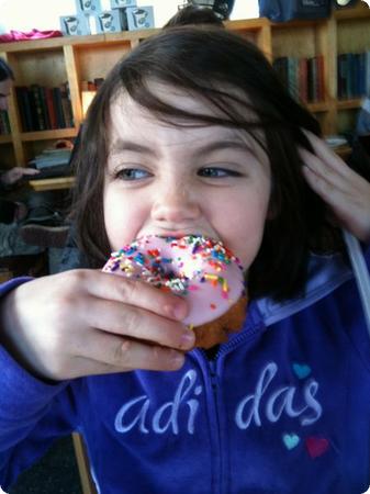 Darya digs into a Doughnut at Top Pot Doughnuts in Seattle