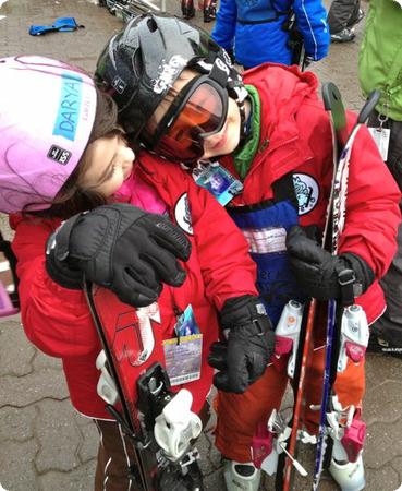 Reunited after a long day of skiing, the kids have a quick cuddle before they start bragging about their accomplishments