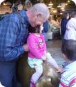 Darya needs some help staying seated on the Pig at Pike Place Market