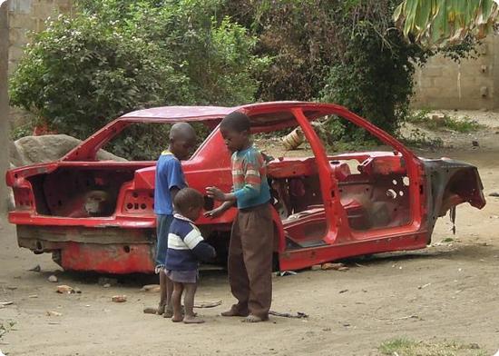 The usable parts of this car have been sold off. Now it's a backdrop to the neighborhood