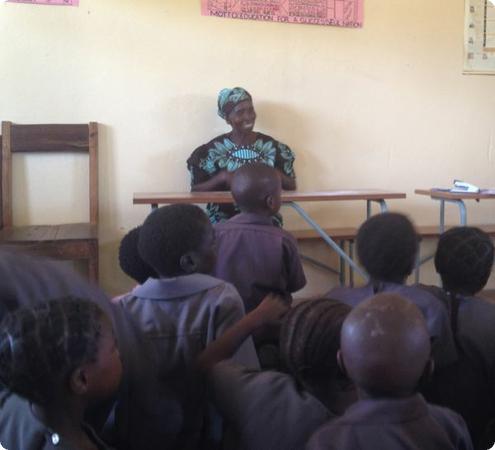 Keeping traditional aural storytelling alive, the village "grandmother" tells the kids a story.