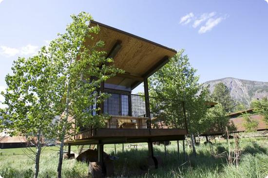 Each hut's balcon looks out over a grassy meadow