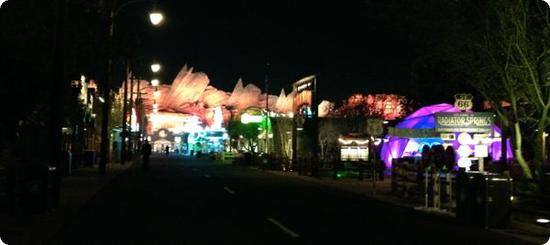 At night the neon in Cars Land flickers to life