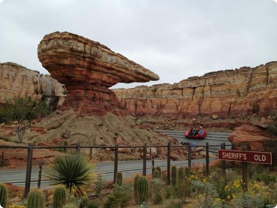 Cars race to the finish line at the Radiator Springs Racers ride in California Adventure