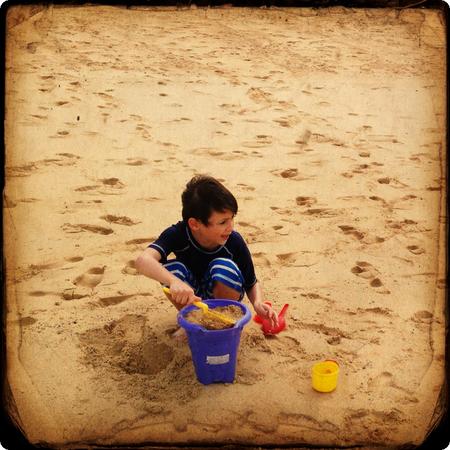 He's about to start building the best sandcastle in the world.  Want to join in?