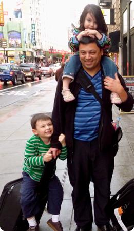 He's working up to carrying three kids and a suitcase at the same time!