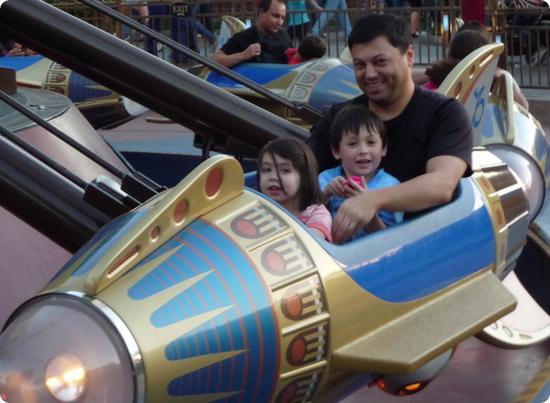 Everest and his dad ride in Disneyland's Astro Orbiter