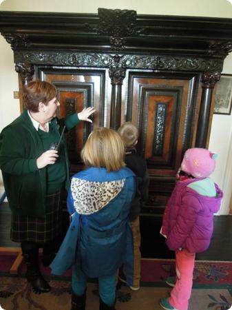 The kids are trying to figure out how this mysterious armoire opens