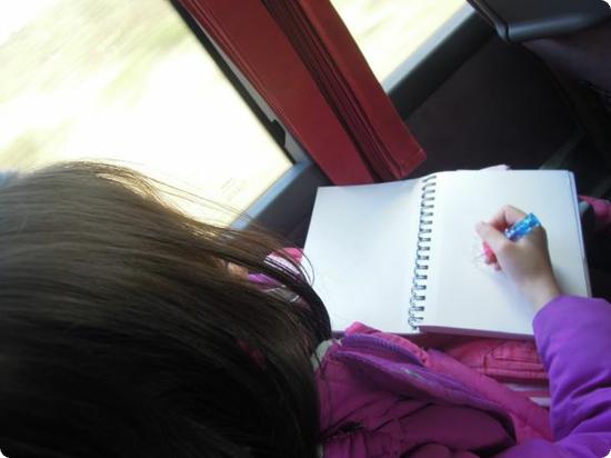 Darya draws the scenery in her journal on one of our bus trips