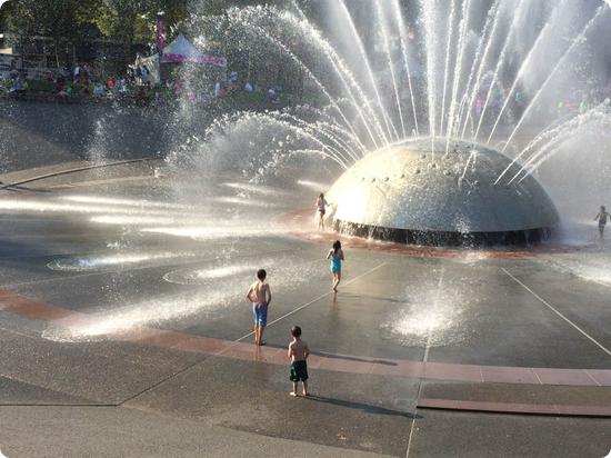 The kids run in International Fountain at Seattle Center